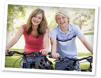 photo of boy and girl on bicycles